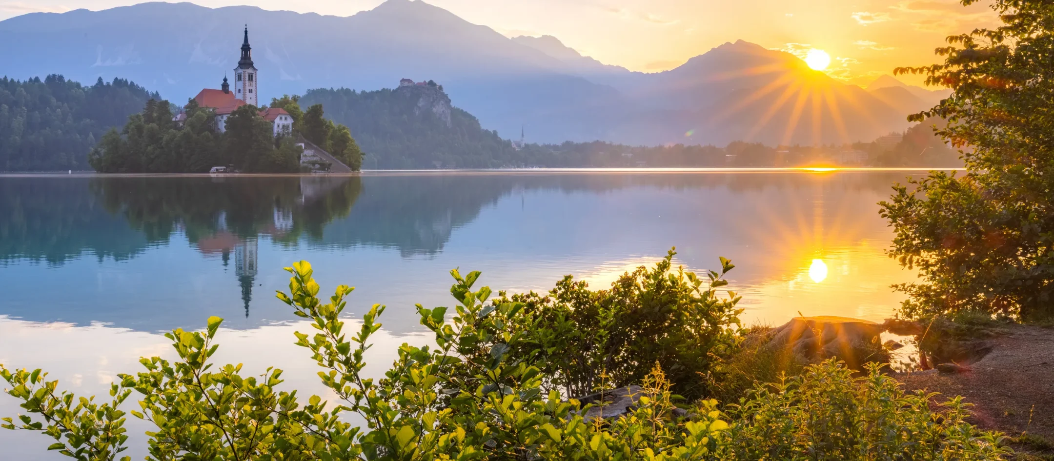 Sunrise over Lake Bled, the island church against the first light