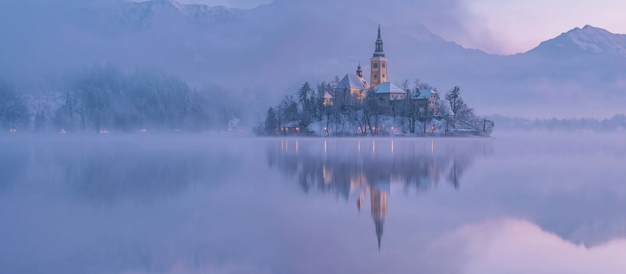 Bled Island in winter mist, lilac light before dawn