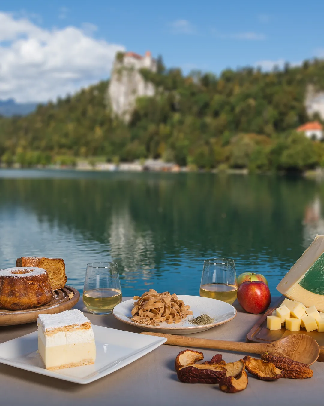 Local Bled produce laid out by the lake, the castle on the cliff behind